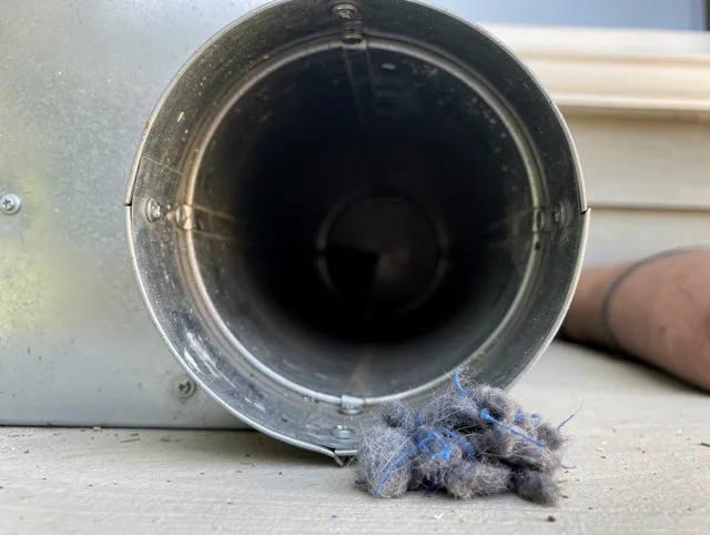 North Olmsted Dryer Vent Cleaning technician using specialized equipment to clear severe dryer vent blockage in North Olmsted
